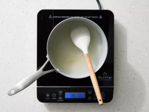 Add sugar and water to a medium saucepan and place over medium heat.