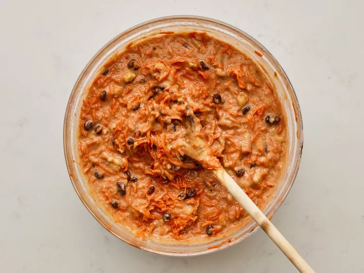 Add the carrot mixture and chopped walnuts to the batter. Stir gently until it all comes together and looks like carrot cake batter should.