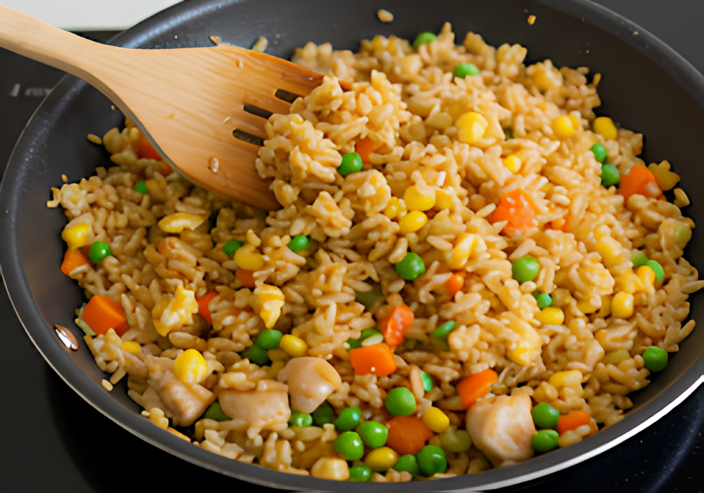 Add the cooked rice, drizzle evenly with soy sauce, and stir well to combine (1)