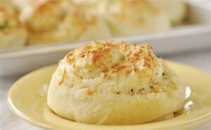 Before baking, I brush the tops with the rest of the butter and add more cheese because obviously. They bake for about 20 minutes until golden and smelling like trouble.