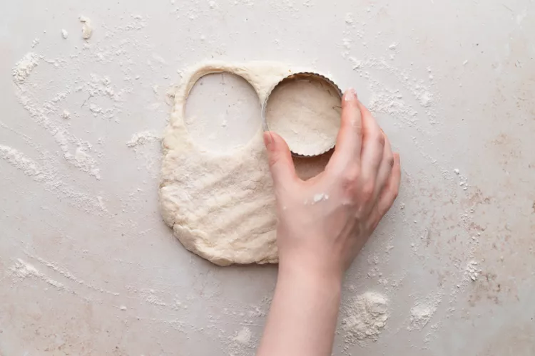 Cut biscuits using a floured cutter, pressing straight down. Place them on the baking sheet