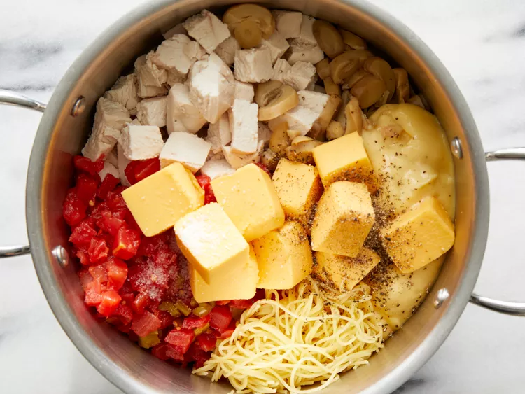 Add the chopped chicken, cream of chicken soup, diced tomatoes with green chiles, processed cheese cubes, and mushrooms