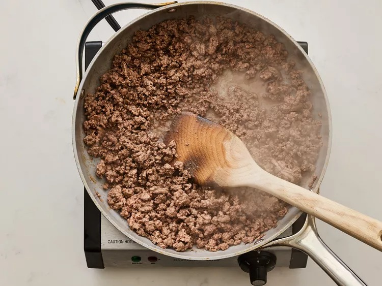 Cook the ground beef in a large skillet over medium-high heat until browned, breaking it into small pieces as it cooks. Drain off any excess grease.