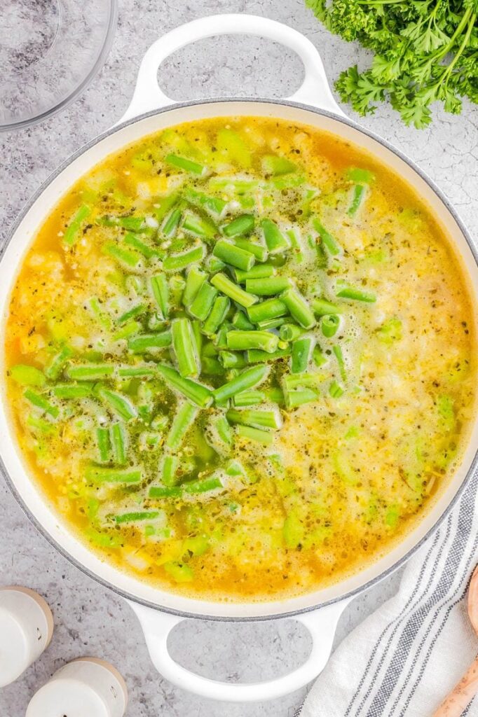 During the last 5 minutes of cooking, add the green beans. If you like them softer, add them earlier. If you like a little crunch, wait until closer to the end.