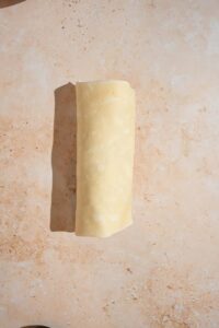 Fold the sides of the tortilla inward, then roll it up tightly from the bottom like you mean it. Repeat with the second tortilla.