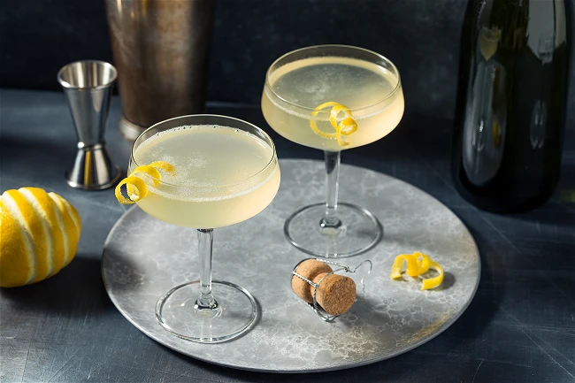 Gently pour chilled Champagne on top and garnish with a lemon twist