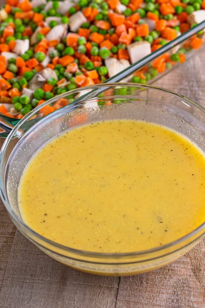 In a bowl, whisk together the cream of chicken soup, chicken broth, garlic powder, onion powder, and black pepper