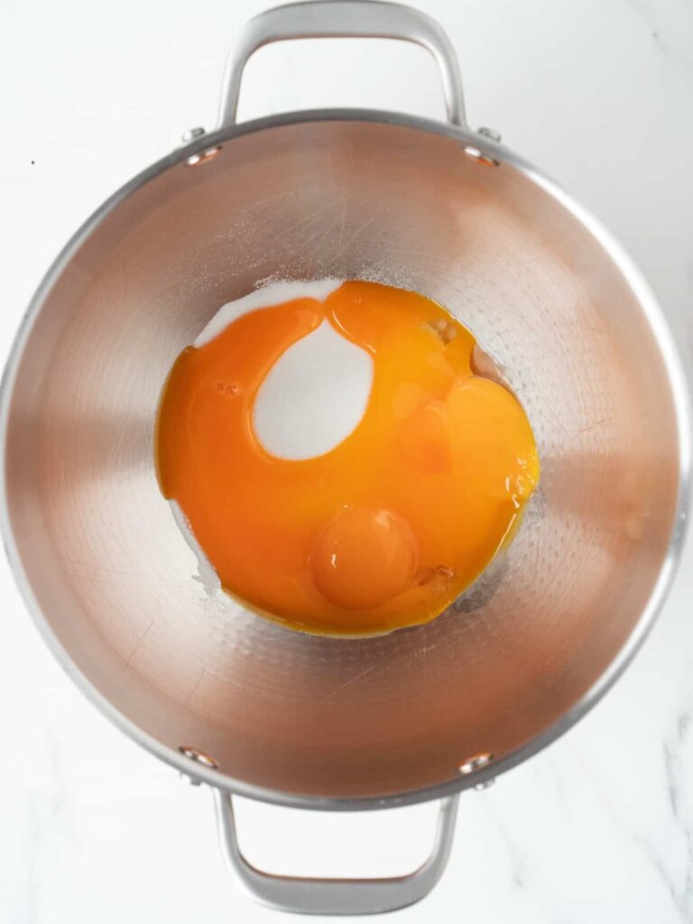 In a stand mixer or using a hand mixer, beat the cold egg yolks and sugar together for about 5 minutes, until the mixture turns pale and thick.