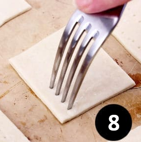 Lay them on a baking sheet, give them fork pokes and brush lightly with the egg wash