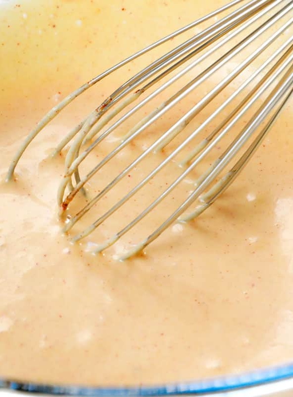 Melt the butter in a microwave-safe bowl, about 1 minute. Stir in mustard, poppy seeds, minced onion, Worcestershire sauce, salt, and pepper