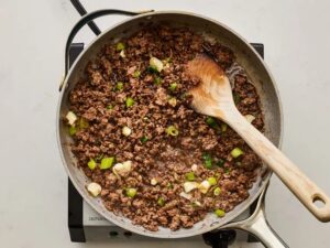 Mix in half of the chopped green onions and remove from heat.