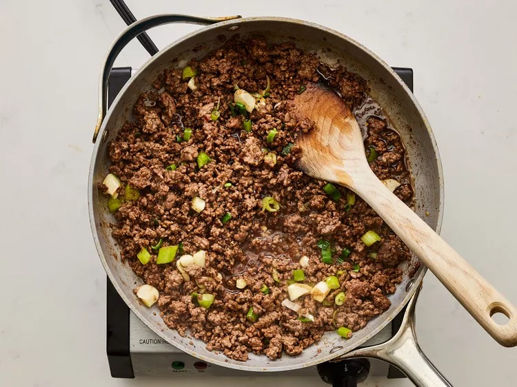 Mix in half of the chopped green onions and remove from heat.