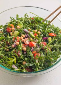 Next comes the garlic, chopped herbs, salt, pepper, lemon juice, olive oil, and red wine vinegar. I mix everything until it looks evenly coated and smells like something good is about to happen.