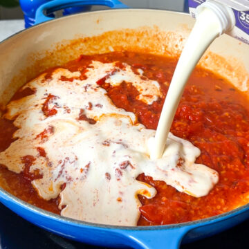 Pour in the cream and stir gently. In a small bowl, mix the flour with about 2 tablespoons of water to make a smooth slurry. Slowly stir that into the sauce. Let it cook 5 to 10 minutes, stirring occasionally, until slightly thickened