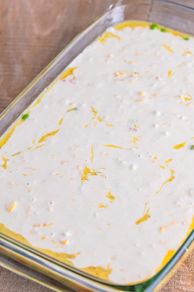 Pour the biscuit mixture evenly over the layers in the baking dish. Do not stir