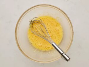 In a large bowl, beat the eggs until they look lighter in color and a little happier.