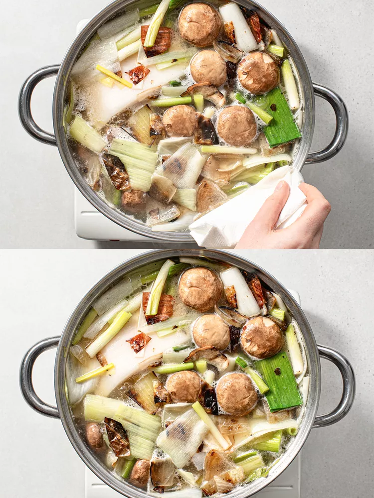 Return cleaned bones to the pot along with charred vegetables, leeks, scallion whites, mushrooms, and pork fatback. Cover with cold water.