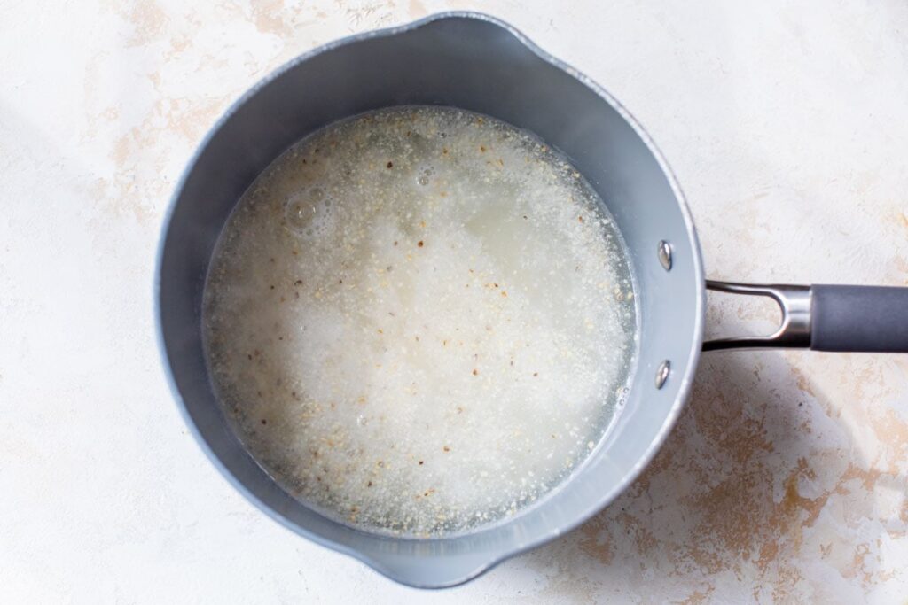 Slowly sprinkle in the grits while stirring to avoid lumps