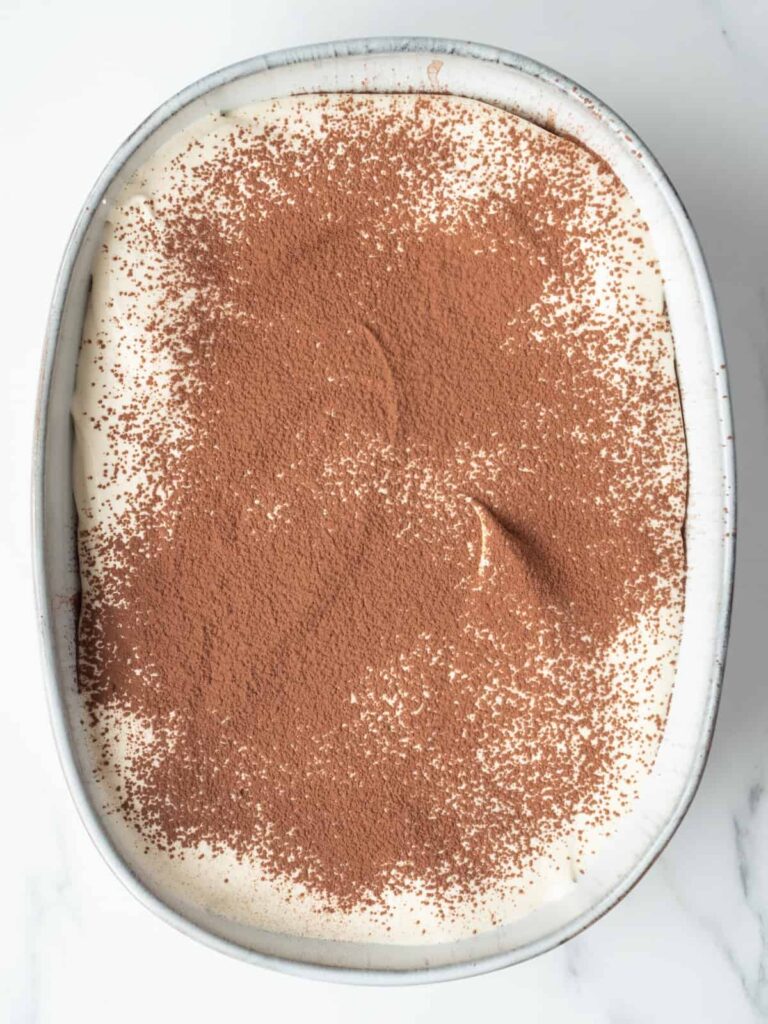 Spread half of the mascarpone mixture evenly over the cookies using the back of a spoon. Dust lightly with cocoa powder.