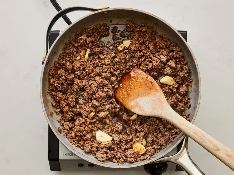 Stir in the soy sauce, brown sugar, and crushed red pepper. Continue cooking until the sauce thickens slightly and coats the beef evenly.