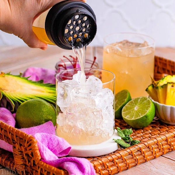 Strain the drink into a glass filled with fresh ice