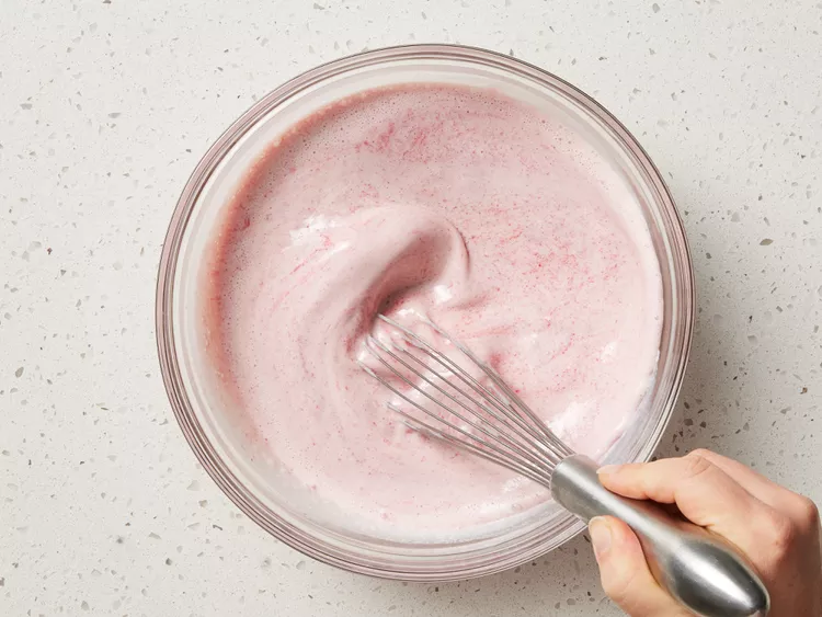 Measure one cup of strawberry puree and whisk it with evaporated milk, condensed milk, and heavy cream
