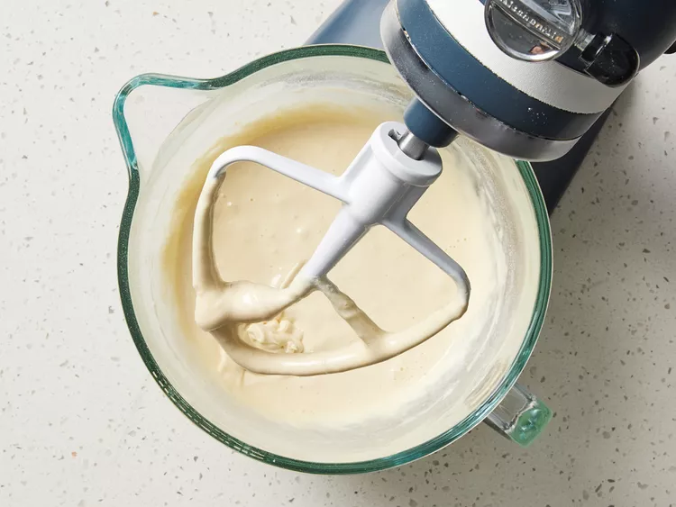 Mix in half of the dry ingredients on low speed, then slowly add the milk