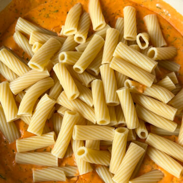 Add parsley, smoked paprika, garlic powder, sugar, and salt and pepper to taste. Then add the cooked rigatoni. Make sure the pasta is al dente or it’ll get mushy later. Nobody wants sad pasta