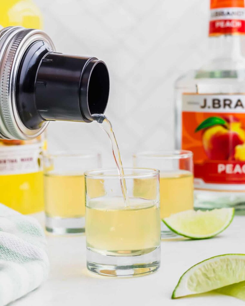 Strain the liquid into a shot glass, leaving the ice behind