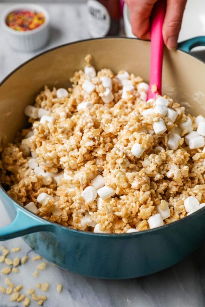 Add the Rice Krispies cereal and the remaining marshmallows. Stir gently until everything is combined and the added marshmallows are just beginning to melt