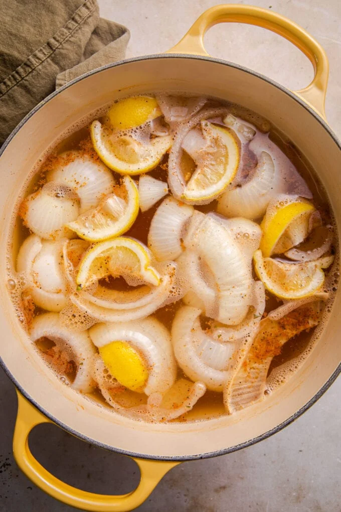 Add the sliced onion and lemon wedges