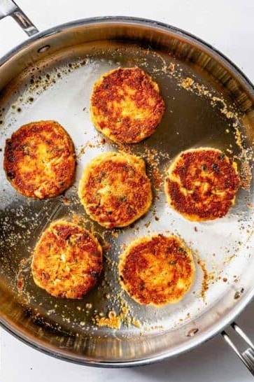 Carefully place the crab cakes in the skillet and cook until browned, about 2 minutes. Gently flip and cook for another 2 minutes