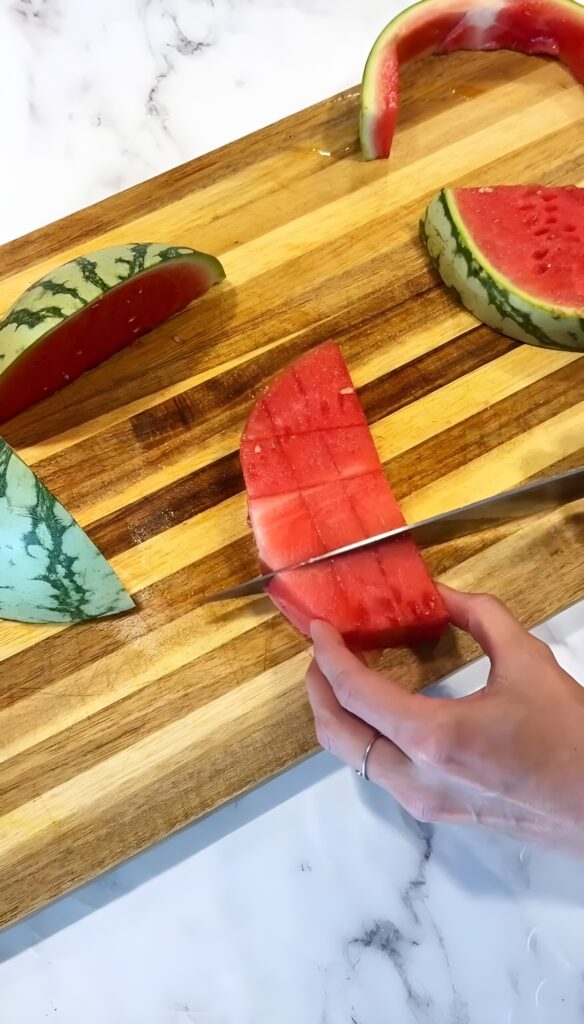 Cut off the rind of the watermelon and chop it into cubes