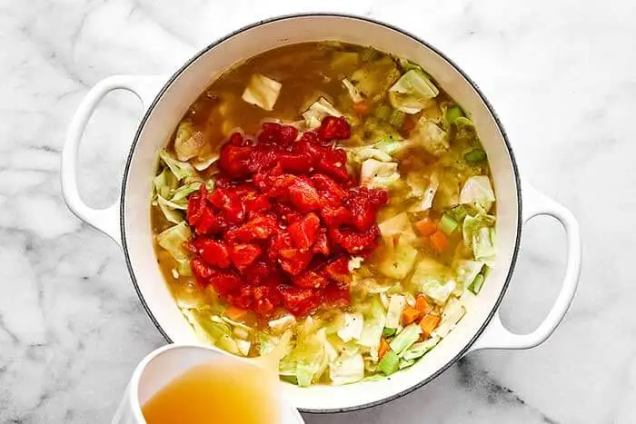 Pour in the diced tomatoes and vegetable broth. Bring to a simmer and cook uncovered for about 10 minutes, or until the vegetables are tender to your liking.