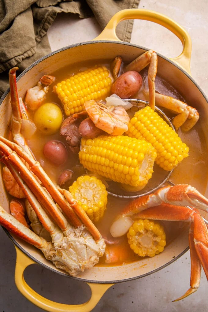 Now add the snow crab legs, shrimp, and corn