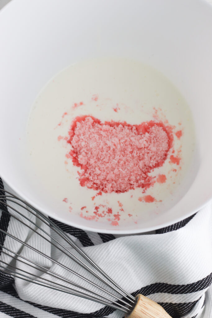 Add 2 tablespoons pink lemonade mix and the heavy whipping cream to a mixing bowl