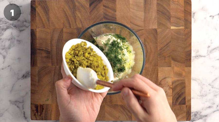 Add the chopped sweet pickles, dill, and finely chopped onion to a medium mixing bowl