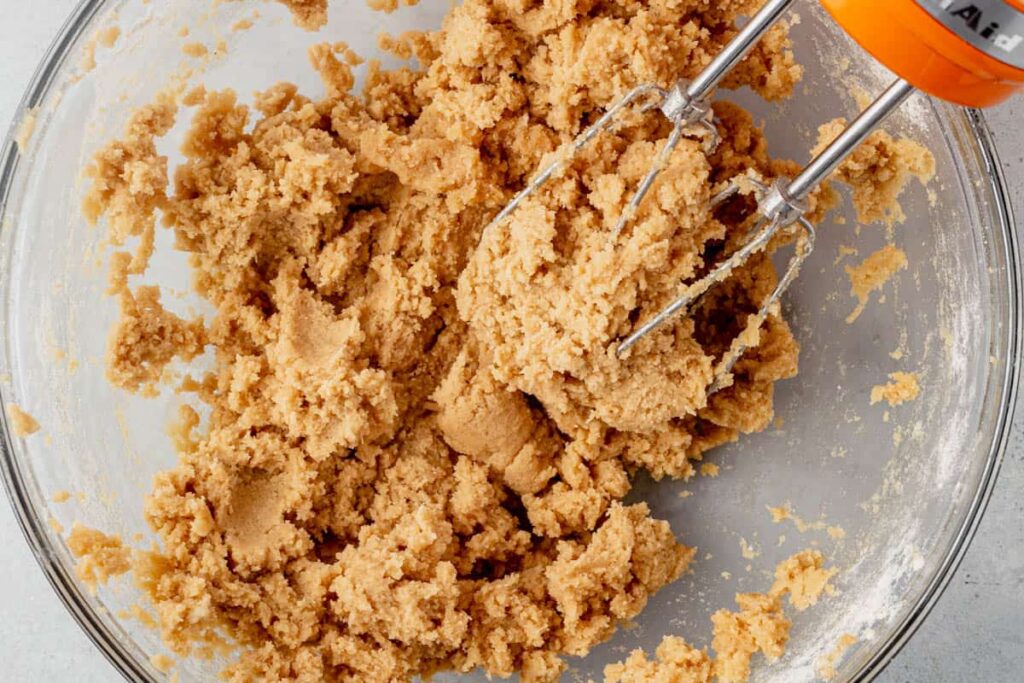 Add the cooled, heat-treated flour and mix until just combined. Add milk one tablespoon at a time until the dough begins to come together