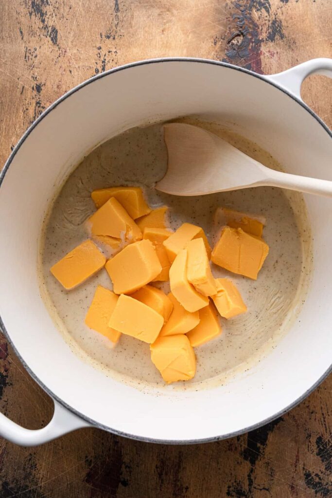 Add the cubed cheese and continue stirring until fully melted and smooth