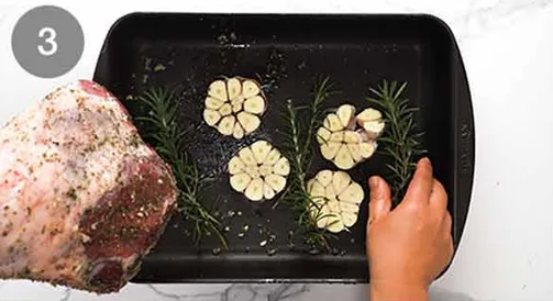 Arrange the halved garlic and rosemary sprigs underneath
