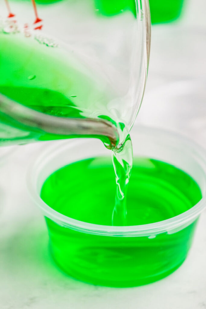 Carefully pour the liquid into the prepared cups, filling each one most of the way while leaving space at the top for sealing