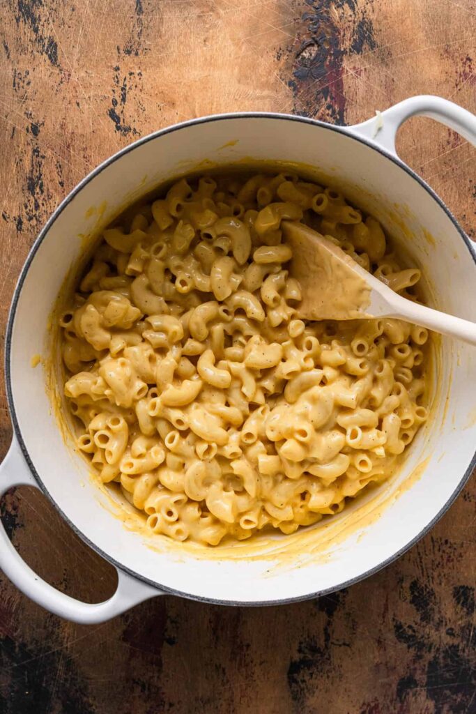 Combine the cooked macaroni with the cheese sauce, mixing gently until evenly coated