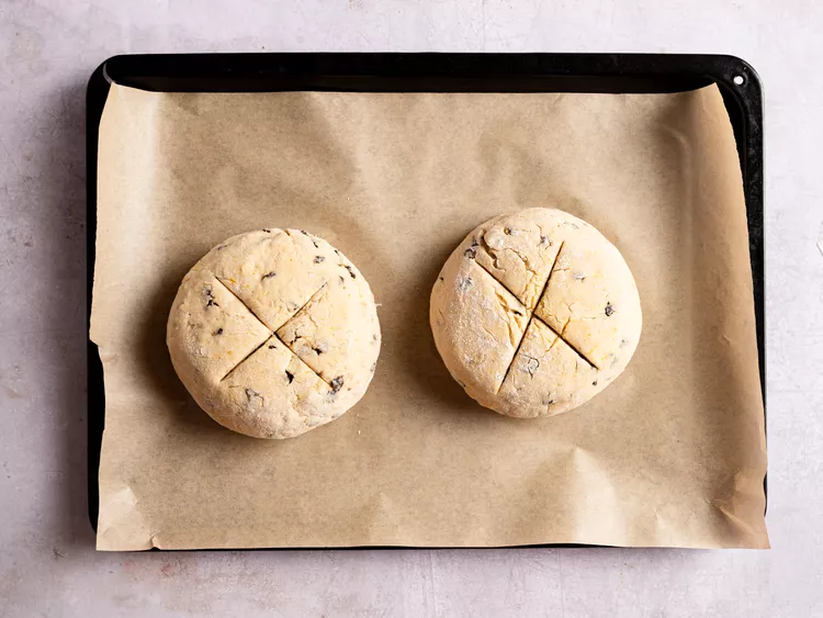 Cut a deep X into the top of each loaf using a serrated knife
