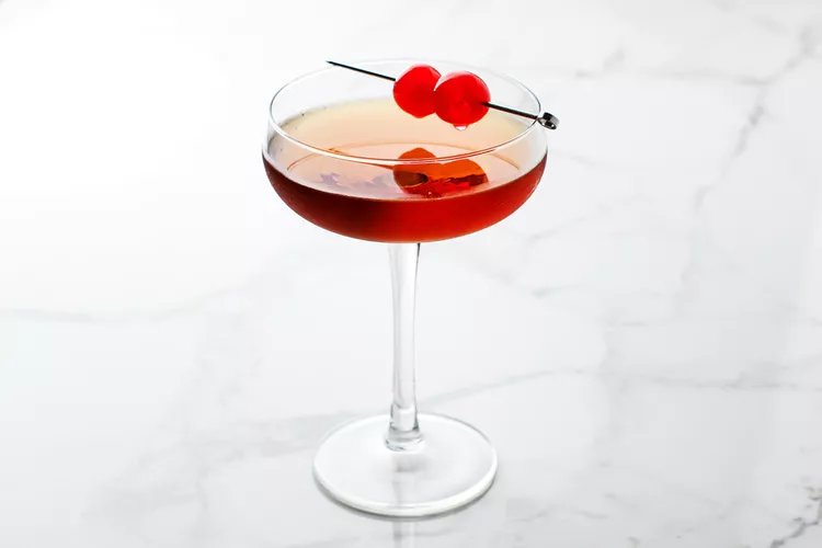 Garnish with a cherry and serve immediately