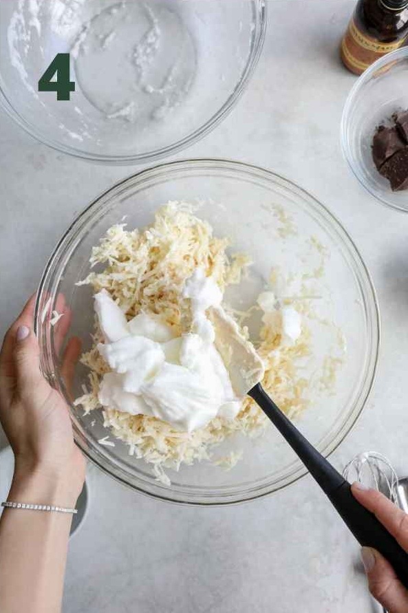 Gently fold the whipped egg whites into the coconut mixture until fully incorporated