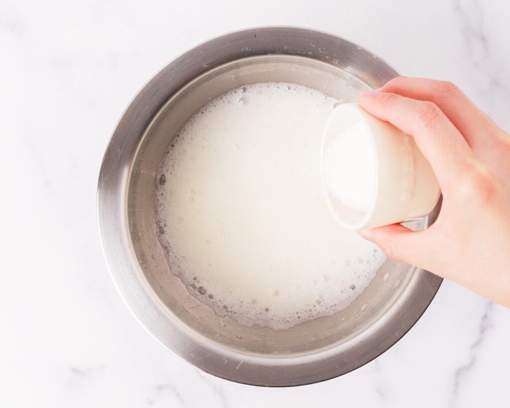 Gradually add sugar while continuing to beat, then increase the speed until stiff peaks form