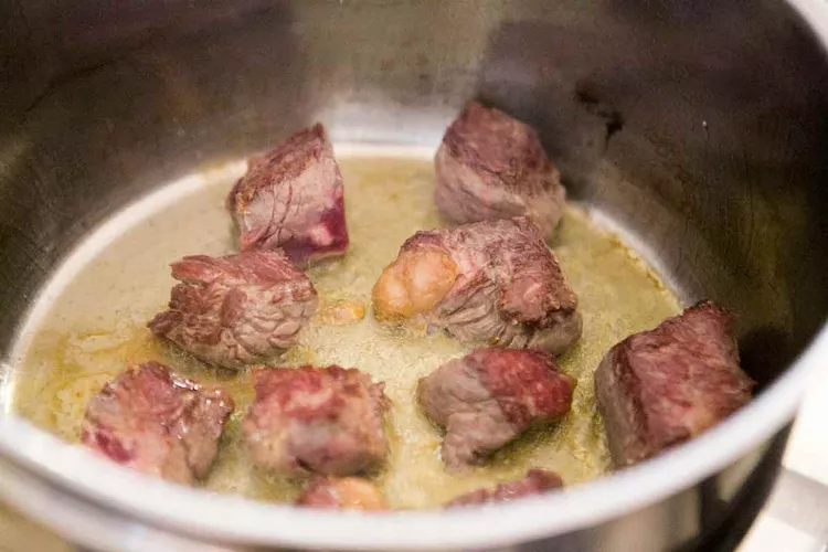 Heat olive oil in a large heavy pot over medium-high heat, then add the beef in batches, allowing each piece to brown deeply on multiple sides without overcrowding the pot