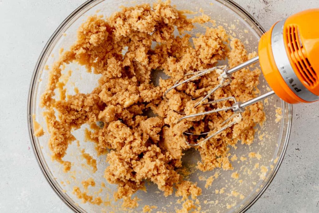 In a large bowl, cream together the softened butter, brown sugar, and granulated sugar using a hand mixer or stand mixer. Beat until light and fluffy, about 1 minute. Mix in vanilla extract and salt