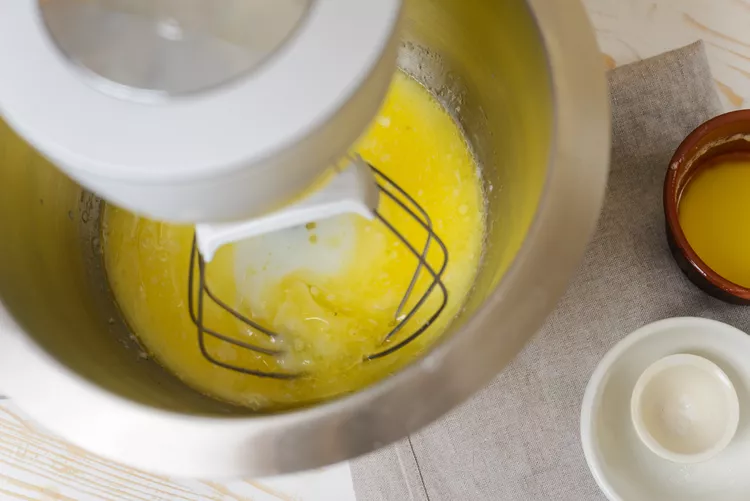 In a large bowl, mix the remaining liquid with melted butter, salt, and sugar until dissolved