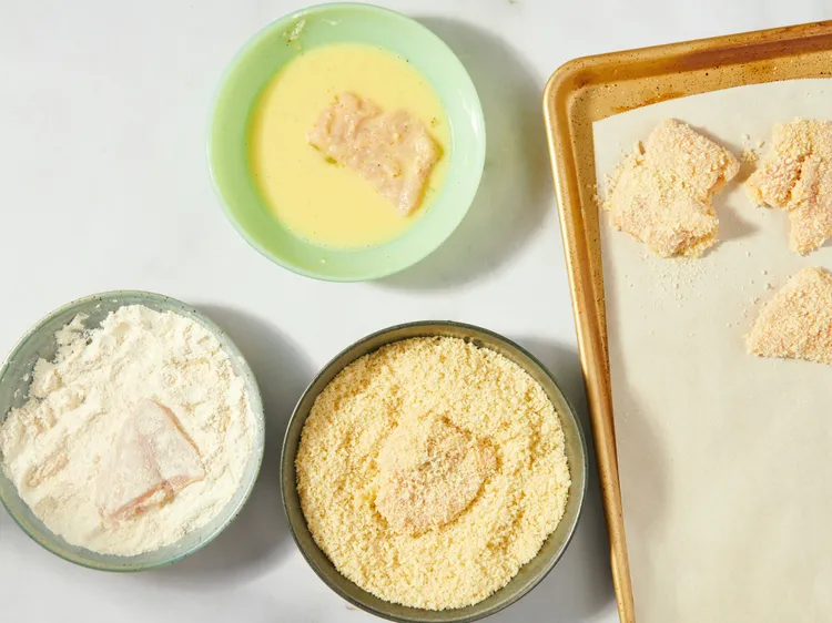 In one shallow bowl, whisk together the egg and water. In another bowl, combine flour with garlic powder, cayenne, coriander, salt, and black pepper. Place panko in a third bowl